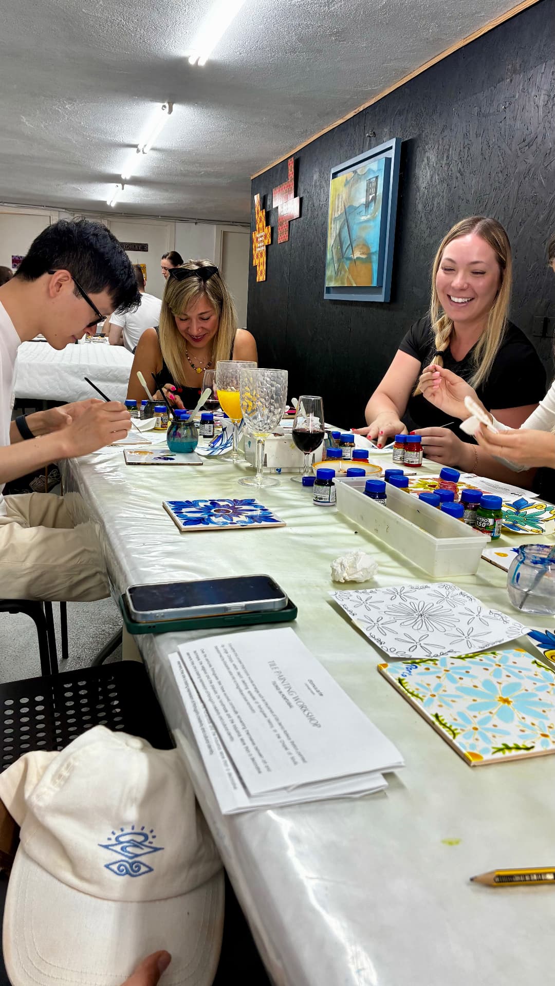 Friends painting ceramic tiles together at a tile-painting workshop in Lisbon