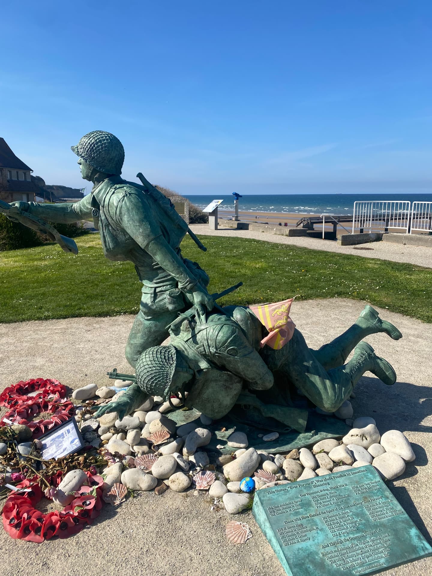 Memorial overlooking the Normandy D-Day landing beaches under a wide grey sky