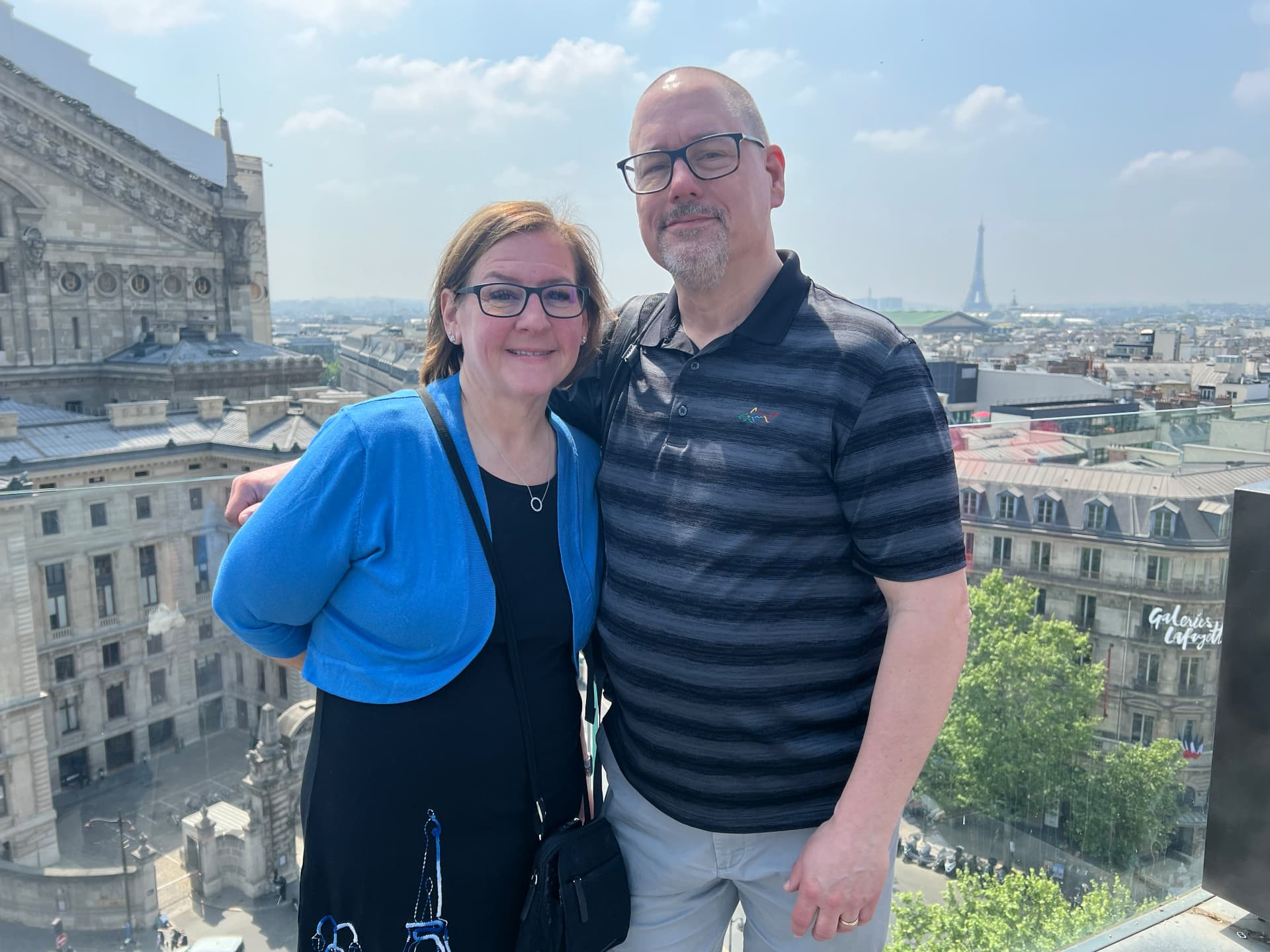 Couple enjoying a romantic rooftop evening overlooking Paris