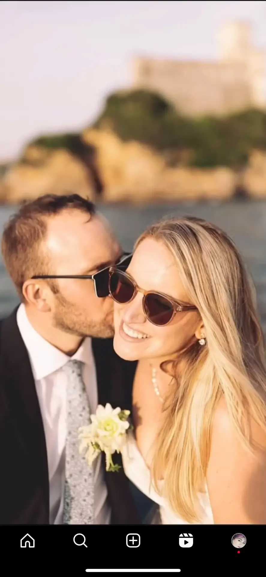 Just-married couple by the sea at golden hour