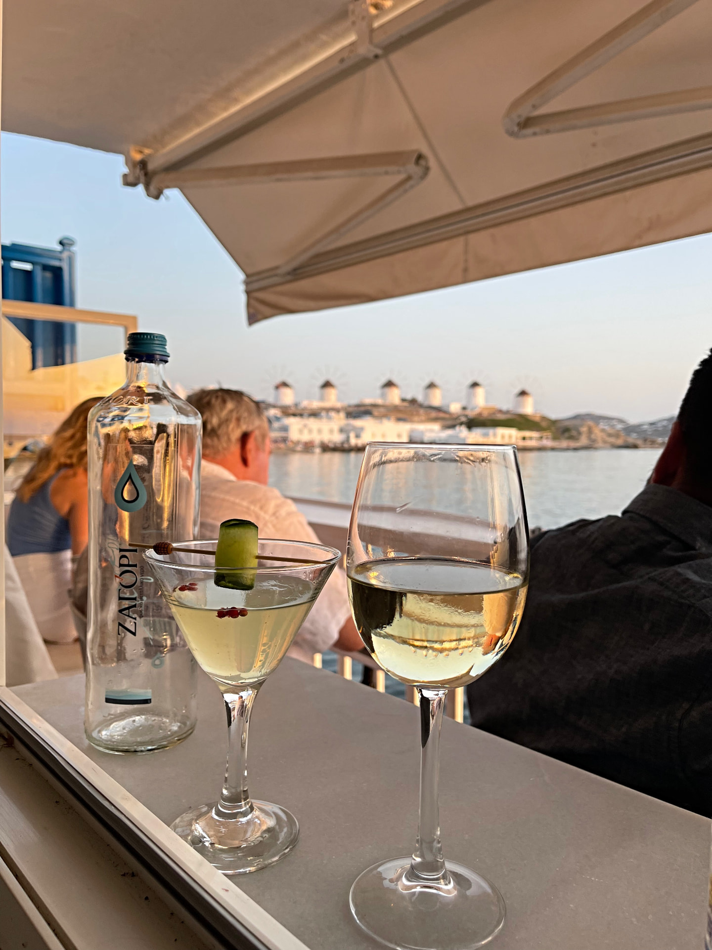 Sunset drinks facing the Mykonos windmills