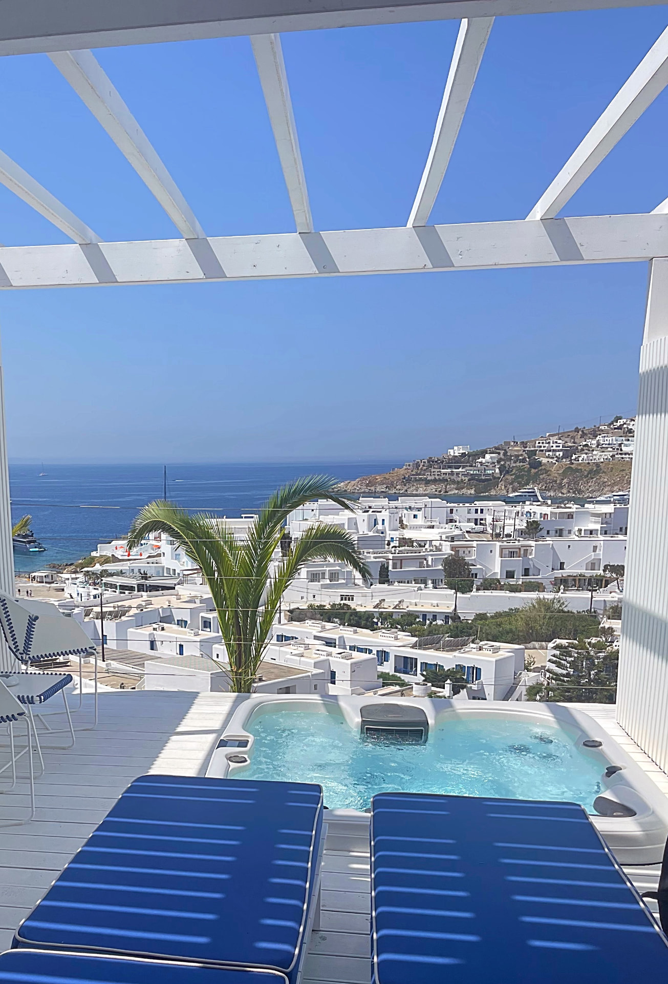Private terrace hot tub above Mykonos bay