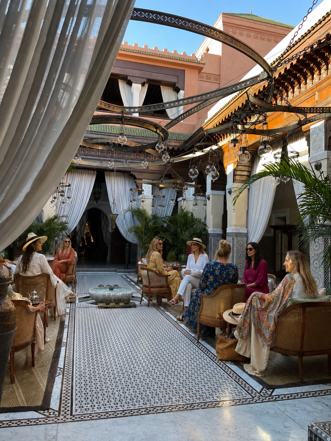 Women celebrating together in a Moroccan riad courtyard