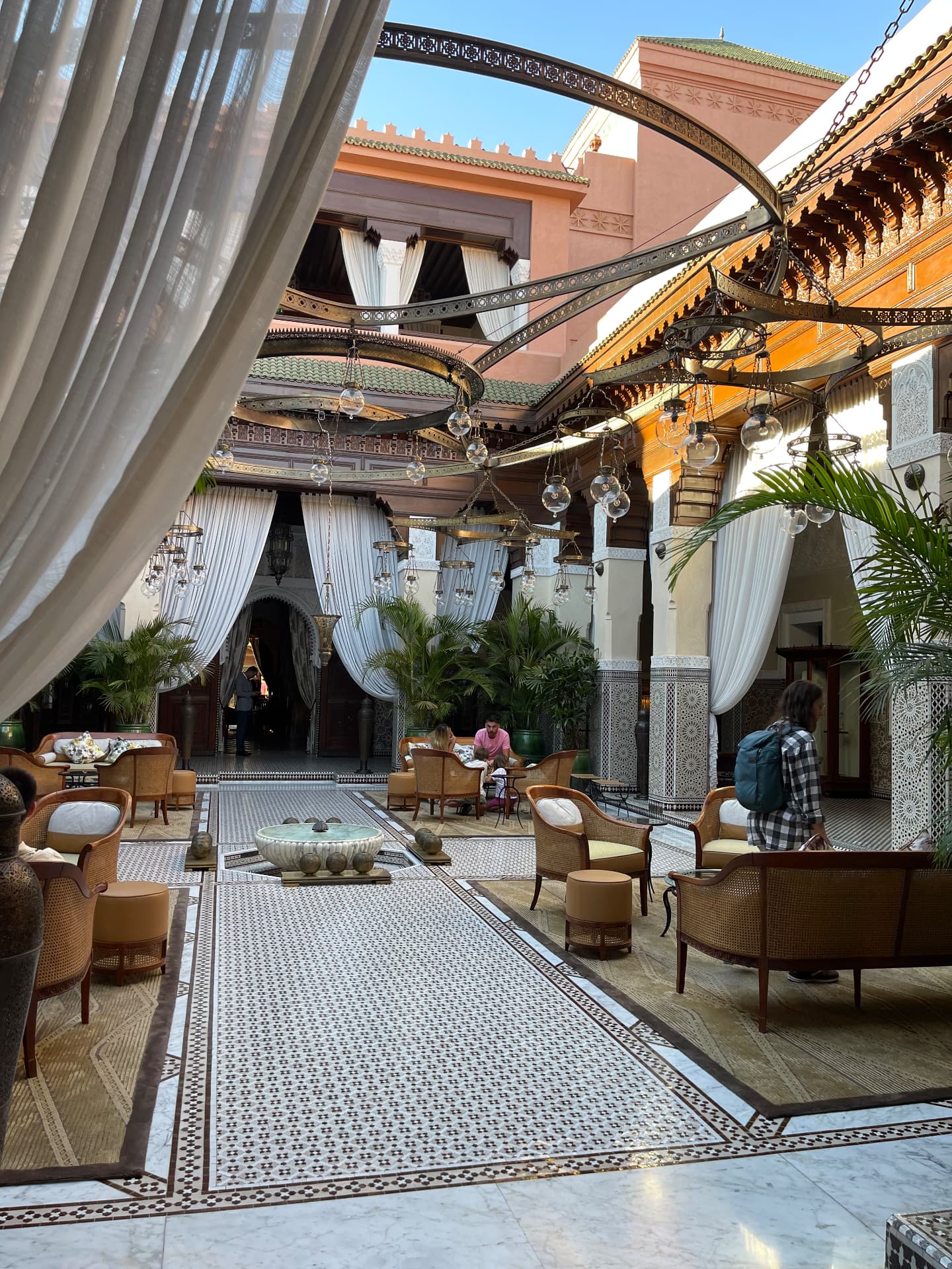 Palace hotel courtyard with lanterns and white drapes in Marrakech