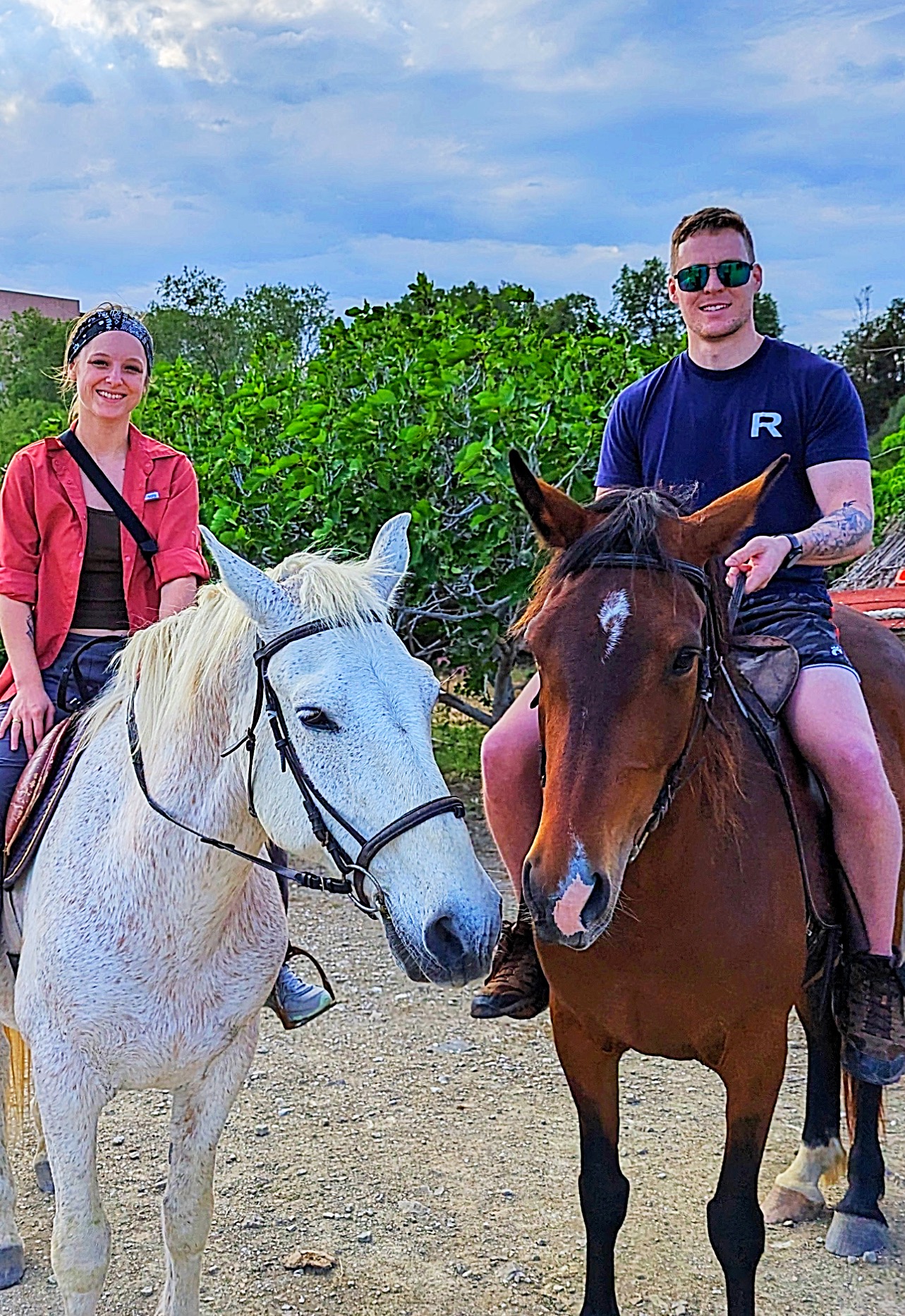 Couple horseback riding on a coastal trail
