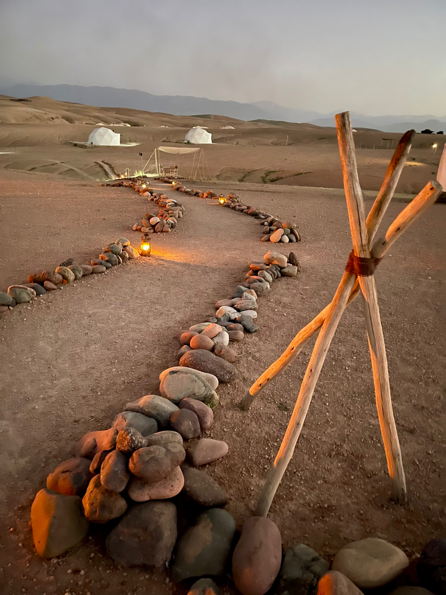 Luxury glamping domes lit by lanterns in the Atlas Mountains at dusk