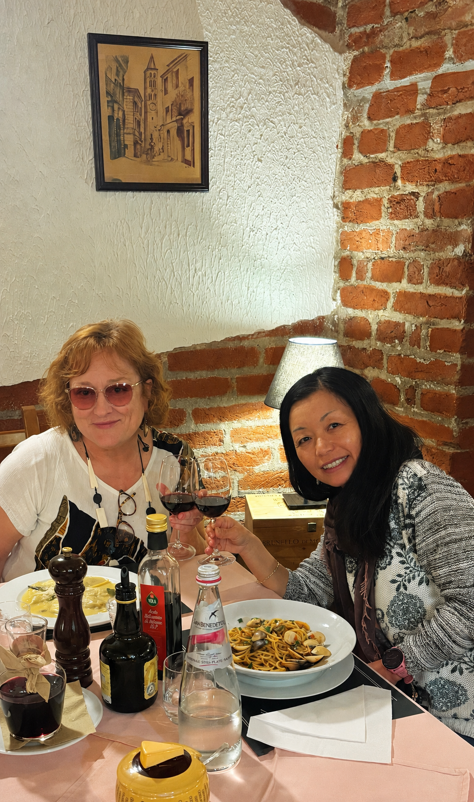 Small group of friends sharing a candlelit dinner in Tuscany