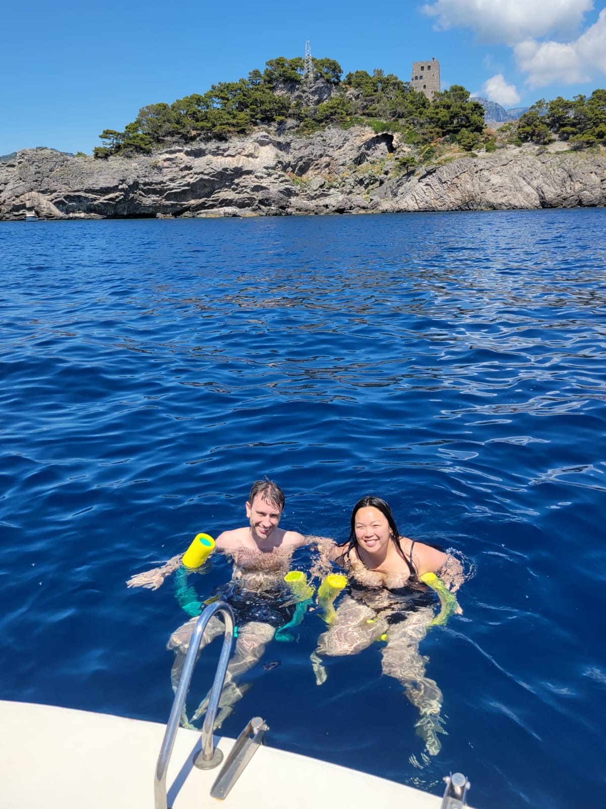 Couple swimming in the deep blue sea off the Amalfi Coast